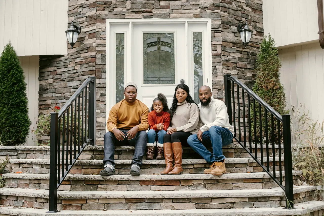 A family sitting together on their front steps