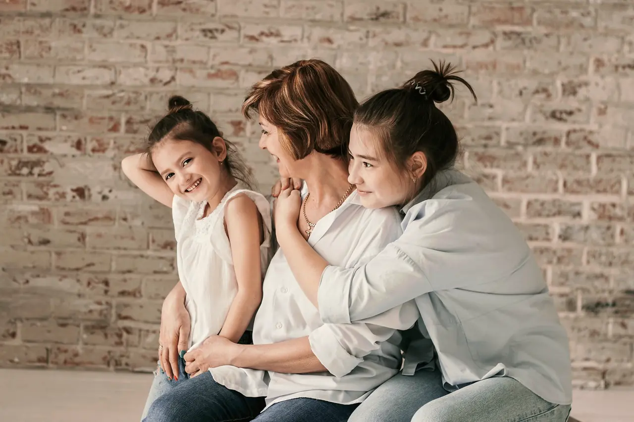 Three generations of a family hugging