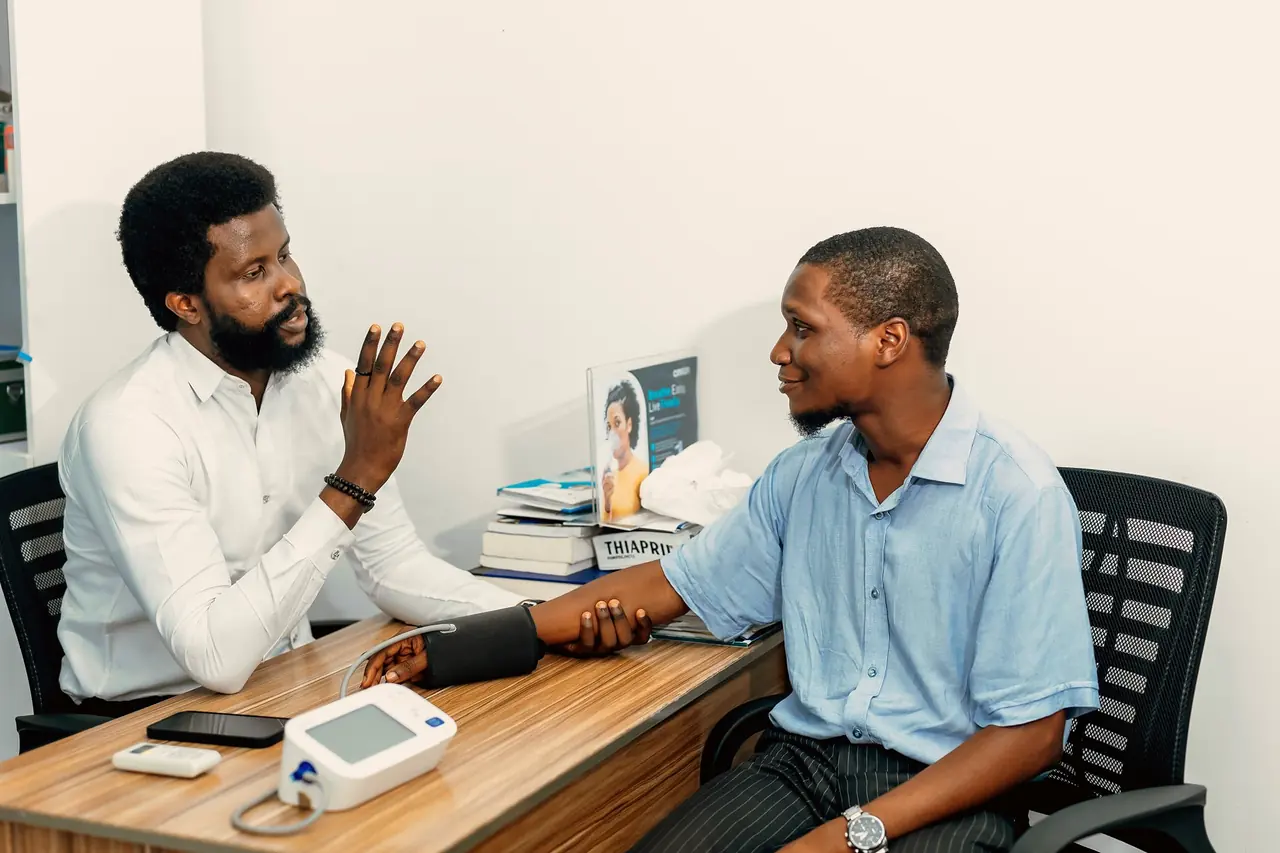 A doctor talking with a patient at a desk